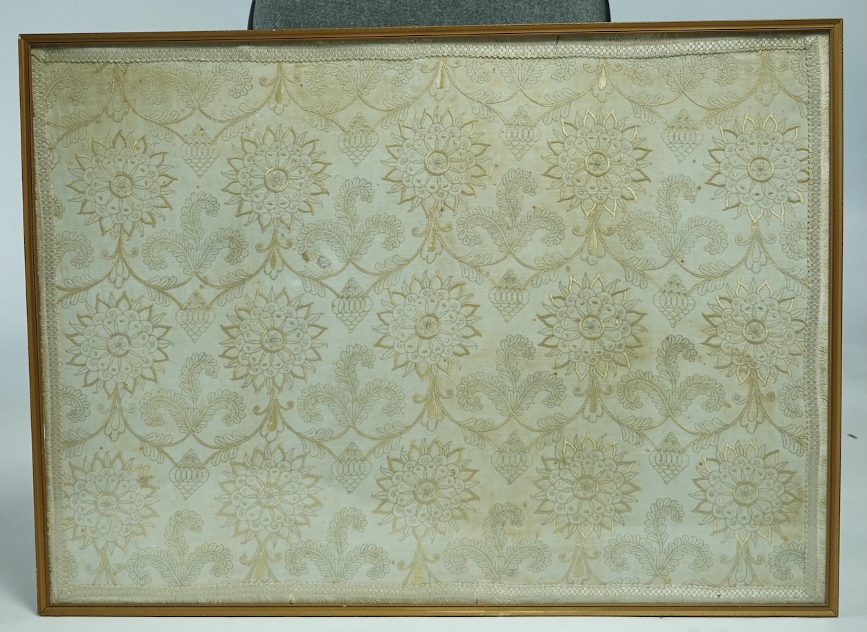 A 17th century fine gold silk thread embroidery, worked on a hand spun linen ground, depicting scrolling three feather motifs, rose shaped flower heads and Persian inspired Botha. Framed., 56cm high x 78cm wide. (Provena